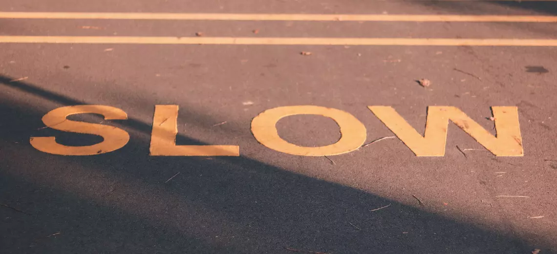 Dieses Bild zeigt eine Straße und den Schriftzug "Slow".